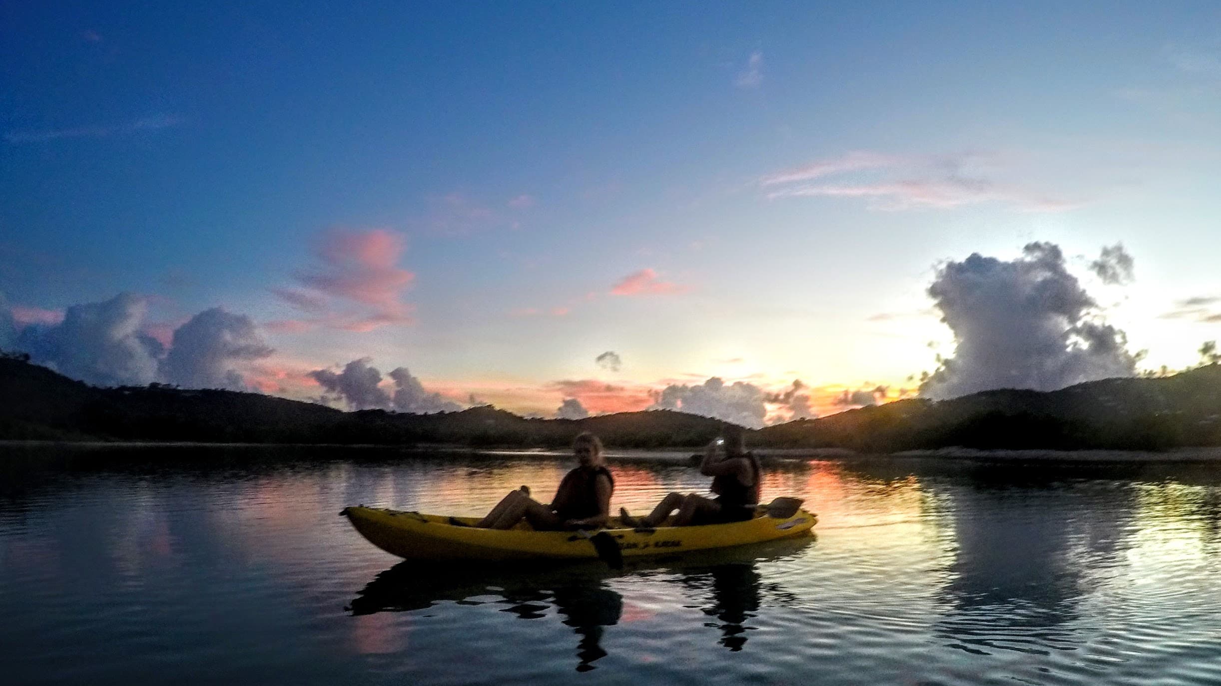 Two kayakers on the still waters of St. Croix at sunset, BushTribe Eco Adventures